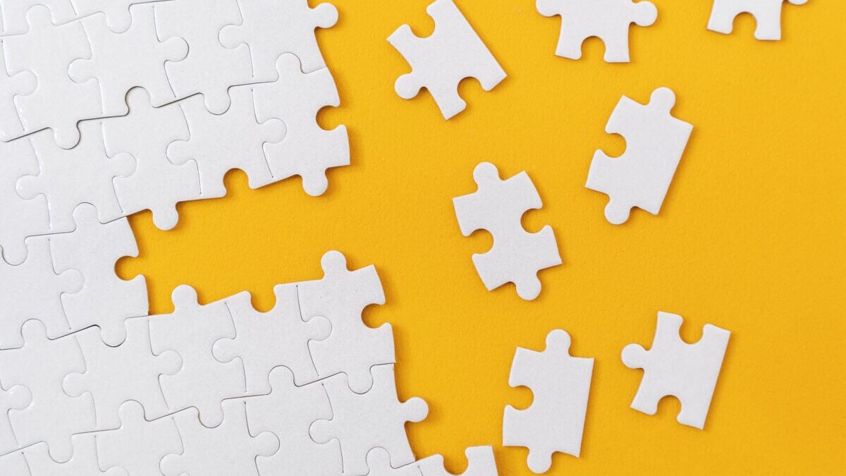 Partially complete jigsaw puzzle with scattered missing pieces